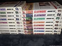Stack of 17 Claymore manga books showing the spines numbered 1 to 17 with the authors name Norihiro Yagi and series title.