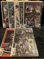 Seven issues of the Ghost in the Shell Man-Machine Interface comic series, issues 2 through 8, individually bagged and shown laid out in two rows.