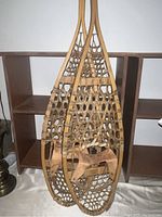 Full view of wooden Rebar snow shoes showing shape, material, and bindings.
