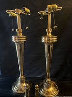 Front view of the pair of vintage brass lamps showing tapered design and dual sockets with pull chains