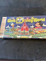 Photo of the closed game box showing vintage Walt Disney World Magic Kingdom artwork with Donald Duck and Mickey Mouse