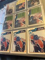 Binder page front showing nine Wayne Gretzky base cards including six identical Edmonton Oilers #99 cards and three additional front-facing cards