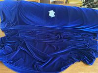 Blue stretch velour fabric spread out to show texture and color.