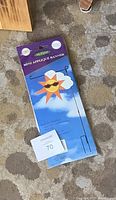 Mini applique banner with a sun wearing sunglasses and stand in packaging