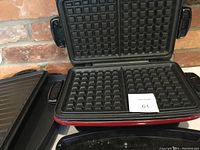 Image of waffle iron grill plate attached to the George Foreman grill showing non-stick surface and grid pattern for waffle making.