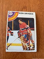 Front side of 1978/79 OPC Ken Dryden hockey card showing the player in red Montreal Canadiens goalie gear on ice.