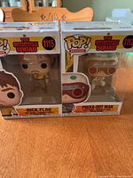 Front view of Rick Flag and Polka-Dot Man Funko Pop figures in sealed box packaging showing characters and branding
