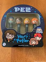 Front view of boxed Harry Potter PEZ dispensers showing four character heads in package with themed artwork.