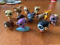 Front view of 12 Littlest Pet Shop animal figurines showing the variety of animal shapes and colors.