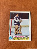 Front side of the 1977/78 OPC Mike Palmateer rookie hockey card showing the player in goalie gear with Toronto Maple Leafs logo and team name.