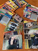 Spread of Naruto collectible cards showing various characters and back designs.