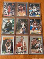 Nine NBA basketball cards displayed in two rows, featuring players in game and posed shots, some in Chicago Bulls uniforms.