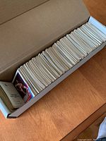 Box full of vertically stacked hockey cards showing the edges and thickness of over 500 cards.