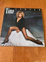 Front cover of Tina Turner Private Dancer vinyl album showing Tina Turner posing in black outfit.