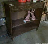 Full view of the vintage wooden bookcase cabinet showing the top and lower open shelves, also showing missing sliding glass doors and some decorative trim.