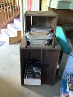 Two stacked antique rustic wooden crates with contents inside the smaller crate not included.