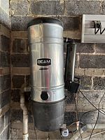 Overall view of Beam central vacuum unit installed on garage wall