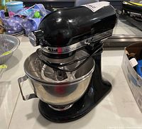 Front side view of black KitchenAid Ultra Power mixer with bowl and wire whip attachment