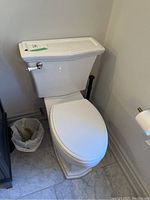Side-angle view of installed toilet showing overall condition and finish