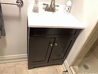 Vanity cabinet and sink overview in bathroom corner