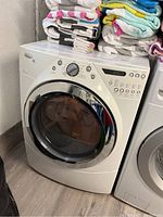 Front-angle view of white Whirlpool Duet Steam dryer next to matching washer