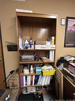 Front view of tall wooden bookshelf filled with various box files, office supplies, and decorative items (contents not included in sale).