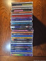 Stack of 28 CD jewel cases with spines showing band and album names mostly in the alternative rock genre.