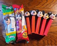 7 Mickey Mouse PEZ candy dispensers including 2 unopened in original packaging and 5 opened with visible heads
