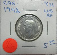 Obverse side of a 1942 Canadian Silver 25 Cent coin showing King George VI profile and inscriptions.