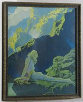 Front view of framed print showing the artwork of a reclining woman on rocky terrain with stylized mountains in background.