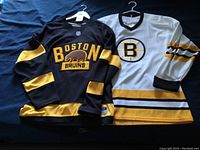 Black and white jerseys laid flat side by side
