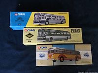Three boxed Corgi Classics bus models displayed together