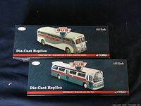 Two Corgi Classics die-cast bus replica boxes showing Yellow Coach 745 and GM Fishbowl models in 1:50 scale.