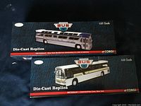 Two Corgi Classics die-cast bus replica boxes showing Greyhound and Command Bus Lines livery in 1:50 scale.