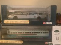 Two Corgi die-cast collectible vehicles in original box packaging, one on top of the other showing exterior detail.