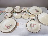Overall set display showing arrangement of plates, cups, bowls, and serving pieces on table