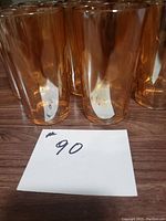 Set of 8 vintage amber carnival glass drinking glasses, showing amber color and approximate height.