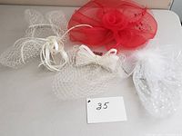 All four fascinators laid out showing red and white colors and varied styles