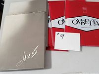 Two Hanes stockings boxes with grey and cream packaging alongside a white card with number 9.