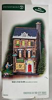 Box of Department 56 Kelly's Irish Crafts Christmas in the City set with picture of the building and figure on front.