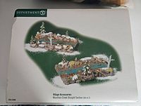 Box front showing Dept 56 logo and illustration of Mountain Creek Straight Section set with two pieces showing rocky creek with snow and trees.