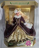 Front view of Happy Holidays Barbie doll in original gold and clear plastic box showing detailed gown and fur accents.
