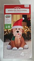 Photo of the Holiday Time English Bulldog inflatable in the original box showing the front panel and product details.