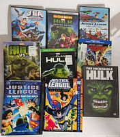 Top view of Justice League and Marvel animated DVD and Blu-ray discs, showing titles and packaging condition.