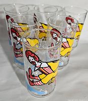 Photo showing all six McDonald's glasses featuring Ronald McDonald illustrations arranged together.