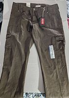Front view of new Levi's misses cargo pants, size 16 medium, showing button and zipper fly, belt loops, and front cargo pocket on right leg with flap and button.