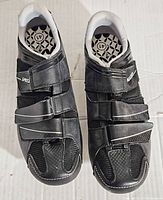 Top view photo of both Specialized Riata cycling shoes showing front and toe area with three black Velcro straps and white padded lining.