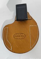 Front side of vintage Pager Pal leather holster showing embossed logo and black clip at top.