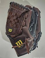 Wilson A475 11.5" baseball glove showing front with woven basket web pocket and Wilson logo patches on brown leather with black lacing.
