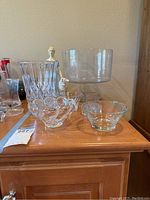Fluted crystal candy dish, crystal pedestal bowl, oval glass bowl arranged on wooden surface